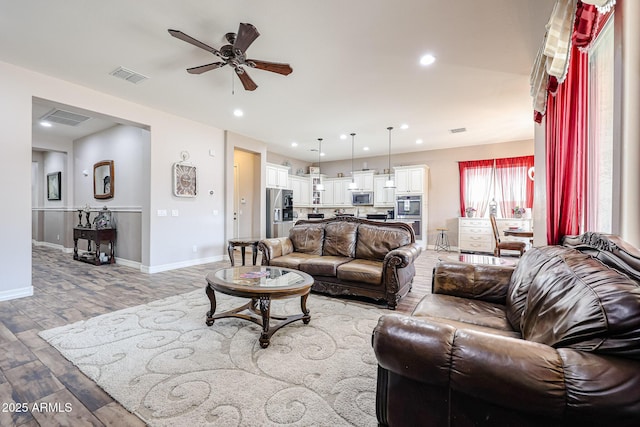 20421 W Legend Trl, Buckeye, AZ 85396 - living room with ceiling fan, light wood-style flooring, baseboards, and recessed lighting