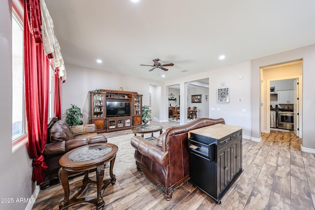 20421 W Legend Trl, Buckeye, AZ 85396 - living room with light wood-style floors, ceiling fan, baseboards, and recessed lighting
