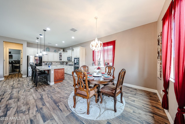 20421 W Legend Trl, Buckeye, AZ 85396 - dining space featuring a chandelier, baseboards, wood finished floors, and recessed lighting