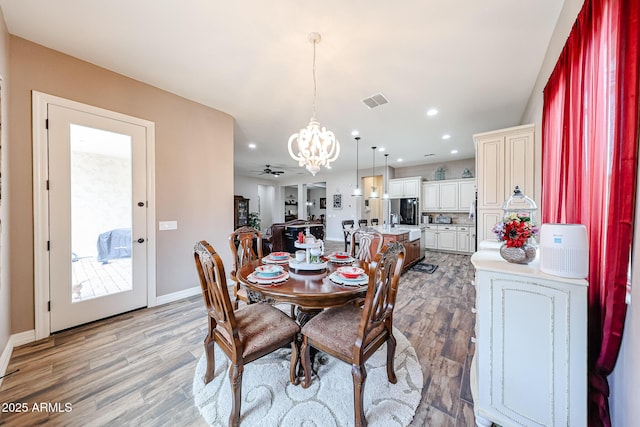 20421 W Legend Trl, Buckeye, AZ 85396 - dining room featuring a chandelier, light wood-style floors, baseboards, recessed lighting, and a ceiling fan