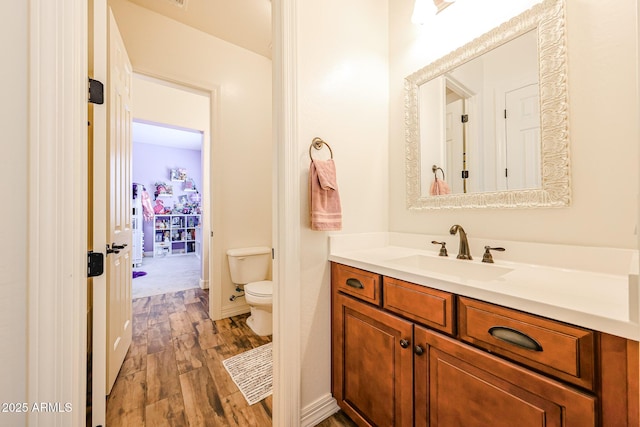 20421 W Legend Trl, Buckeye, AZ 85396 - bathroom with toilet, vanity, and wood finished floors