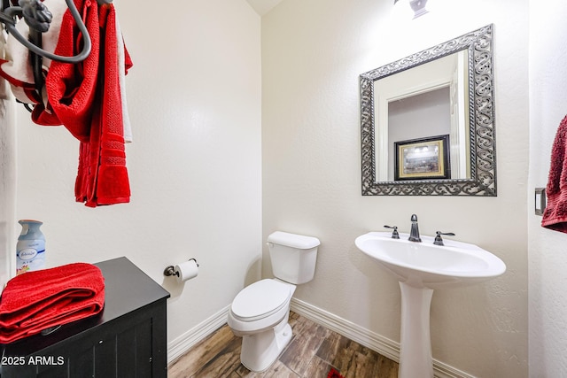 20421 W Legend Trl, Buckeye, AZ 85396 - half bath featuring wood finished floors, toilet, and baseboards