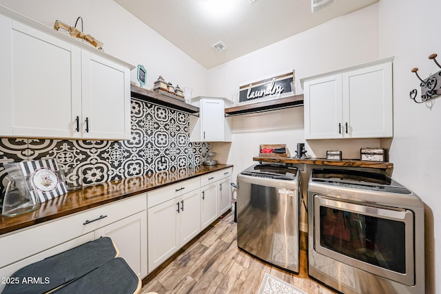 20421 W Legend Trl, Buckeye, AZ 85396 - kitchen with washer and clothes dryer, light wood-type flooring, white cabinets, tasteful backsplash, and wood counters