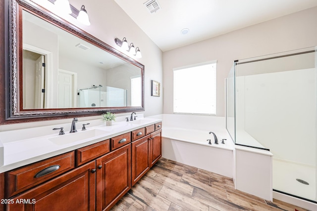 20421 W Legend Trl, Buckeye, AZ 85396 - full bathroom featuring a shower stall, double vanity, a bath, and wood finished floors