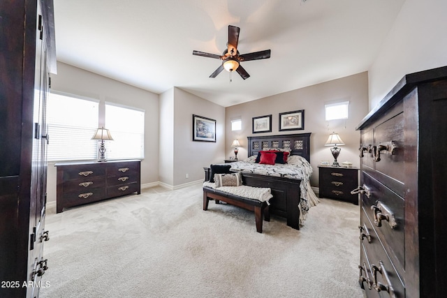 20421 W Legend Trl, Buckeye, AZ 85396 - bedroom featuring light carpet, multiple windows, baseboards, and a ceiling fan