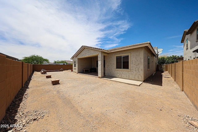 20421 W Legend Trl, Buckeye, AZ 85396 - rear view of house with a fenced backyard, stucco siding, and a patio