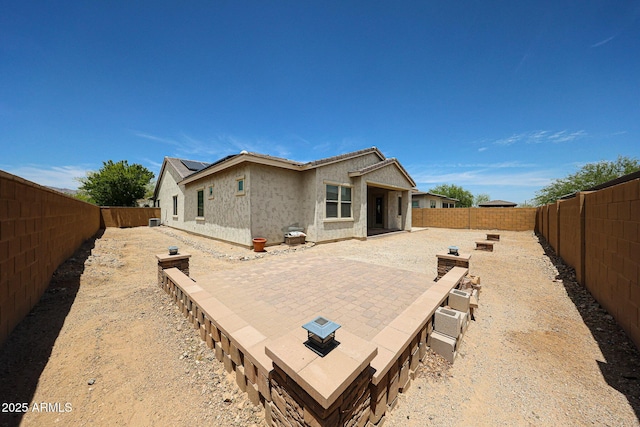 20421 W Legend Trl, Buckeye, AZ 85396 - back of house featuring stucco siding, a fenced backyard, a patio area, and solar panels