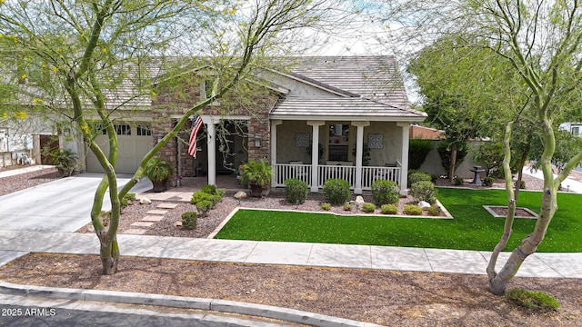 20421 W Legend Trl, Buckeye, AZ 85396 - view of front of house featuring a porch, stucco siding, concrete driveway, a front lawn, and a garage