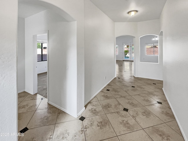 corridor with light tile patterned floors