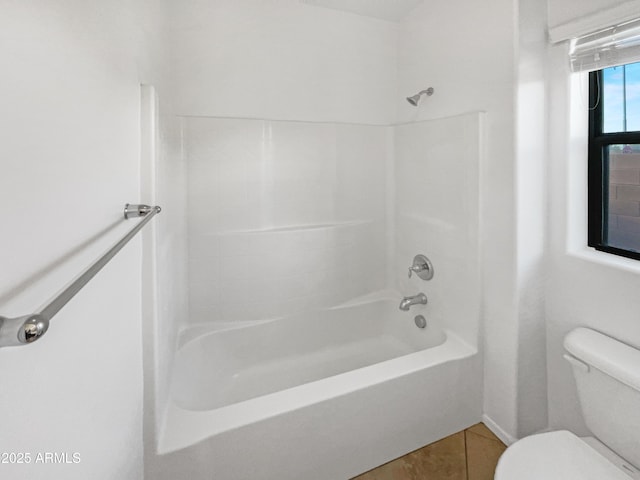 bathroom with bathtub / shower combination, tile patterned floors, and toilet