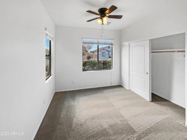 unfurnished bedroom with ceiling fan, carpet, and a closet