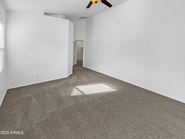 carpeted spare room with ceiling fan and lofted ceiling