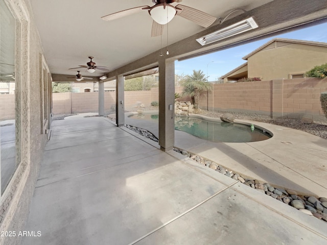 view of patio featuring ceiling fan and a fenced in pool