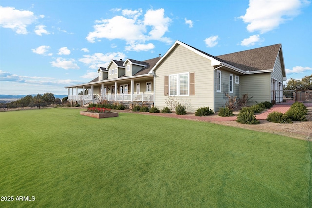 view of front of house featuring a garage, a front yard, and covered porch