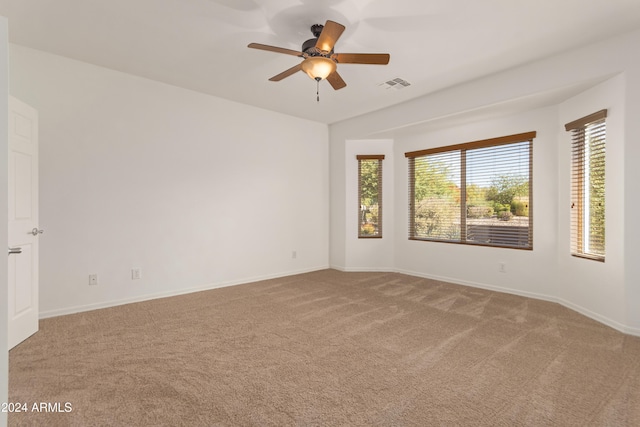 carpeted empty room featuring ceiling fan