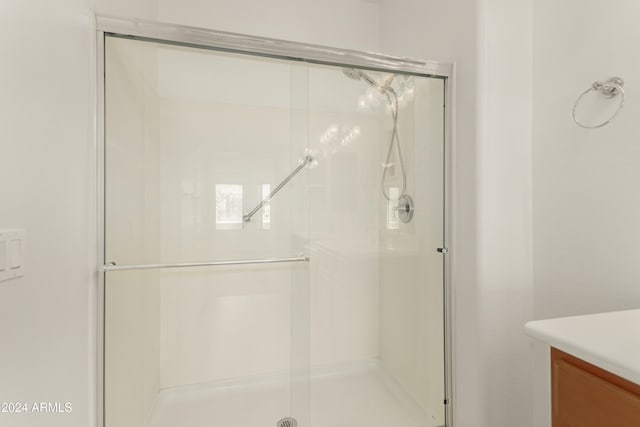 bathroom with a shower with shower door