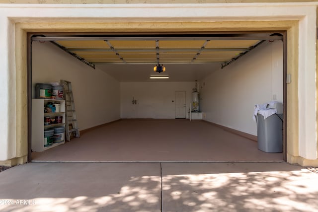 garage with secured water heater and a garage door opener