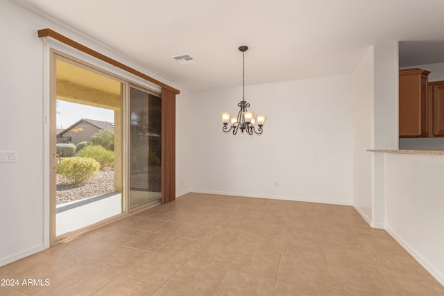 unfurnished dining area with light tile patterned flooring and a notable chandelier