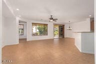 unfurnished living room featuring ceiling fan