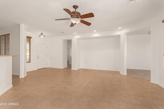 unfurnished living room with ceiling fan and light tile patterned floors