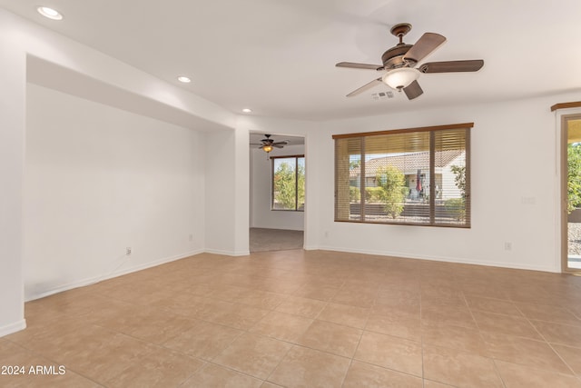 tiled empty room with ceiling fan