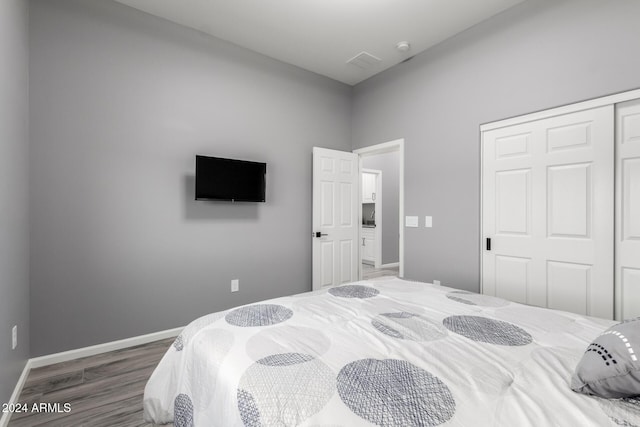 bedroom featuring dark hardwood / wood-style flooring and a closet