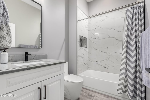 full bathroom featuring vanity, toilet, shower / bathtub combination with curtain, and hardwood / wood-style flooring