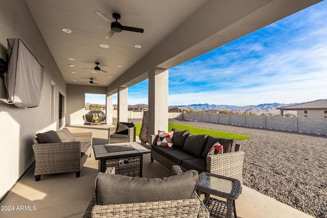 view of patio featuring an outdoor living space and a mountain view