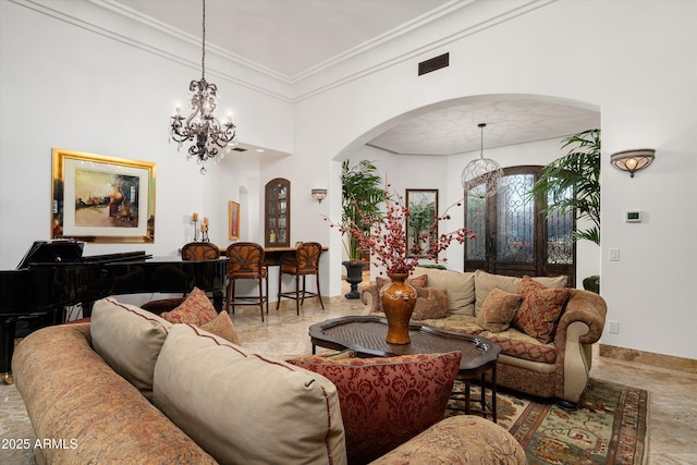 living room featuring crown molding and a chandelier