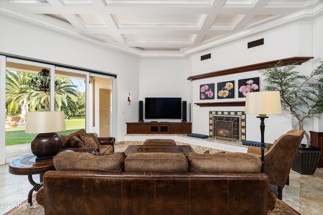 living room featuring beamed ceiling, ornamental molding, coffered ceiling, and a tiled fireplace