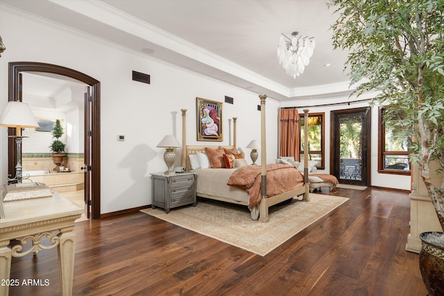 bedroom featuring dark hardwood / wood-style floors, a notable chandelier, access to exterior, crown molding, and ensuite bath