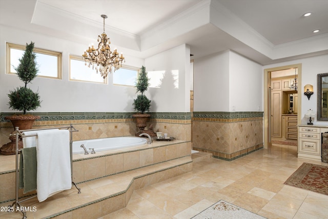 bathroom with crown molding, a healthy amount of sunlight, and a tray ceiling