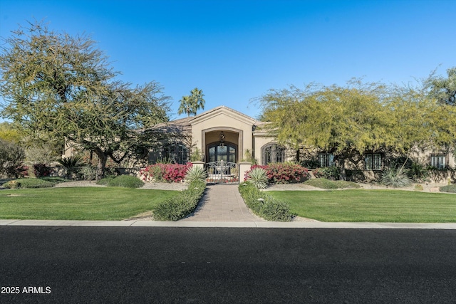 view of front of home with a front lawn and french doors