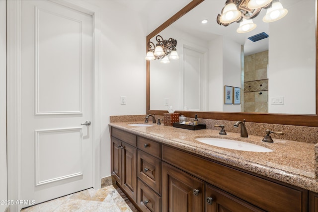 bathroom with vanity and a chandelier