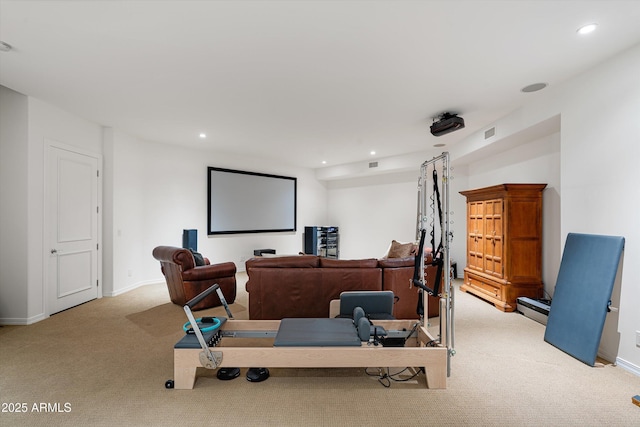 home theater room featuring light carpet