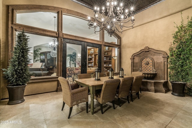 dining room with a towering ceiling and french doors