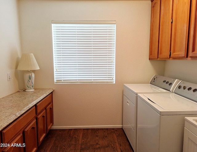 laundry area with cabinets, separate washer and dryer, and dark wood-type flooring