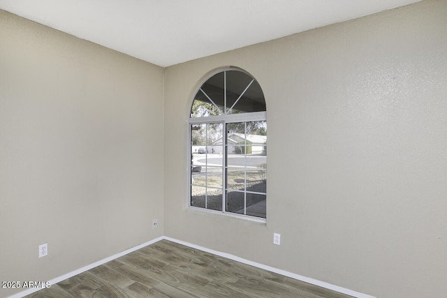 unfurnished room with dark hardwood / wood-style floors