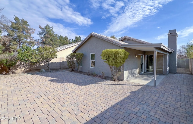 rear view of house with a patio