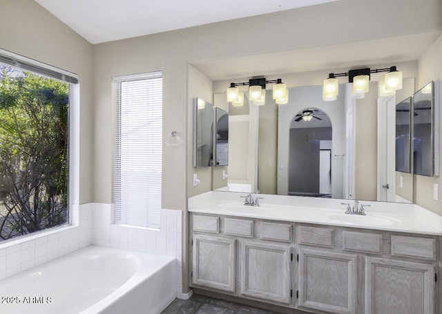 bathroom featuring vanity, a bathing tub, and ceiling fan