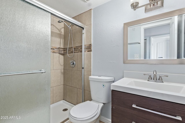 bathroom featuring toilet, walk in shower, and vanity