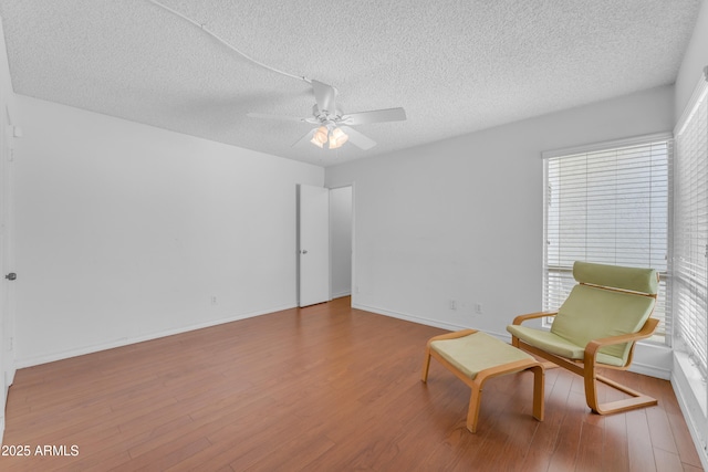 11465 N 56th St, Scottsdale, AZ 85254 - living area featuring a textured ceiling, wood finished floors, ceiling fan, and healthy amount of natural light