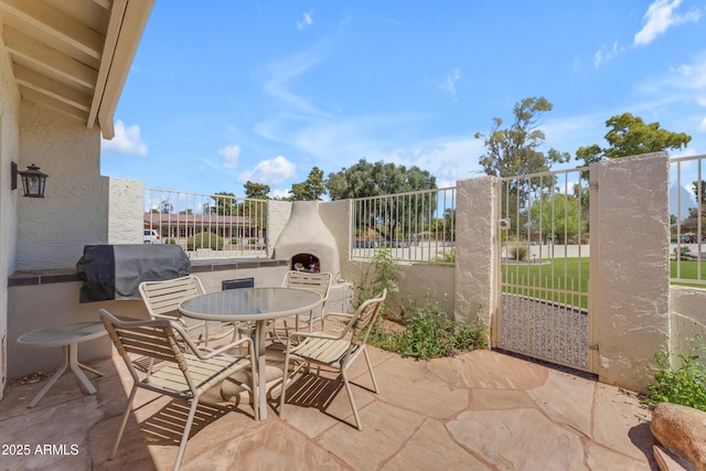 11465 N 56th St, Scottsdale, AZ 85254 - view of patio / terrace with a grill, outdoor dining space, and fence