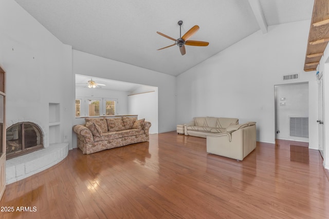 11465 N 56th St, Scottsdale, AZ 85254 - living room with a ceiling fan, high vaulted ceiling, wood finished floors, a fireplace, and beam ceiling
