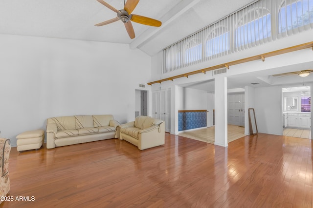 11465 N 56th St, Scottsdale, AZ 85254 - unfurnished living room with ceiling fan, light wood-style floors, beam ceiling, high vaulted ceiling, and healthy amount of natural light