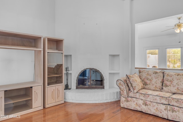11465 N 56th St, Scottsdale, AZ 85254 - living room with a ceiling fan, wood finished floors, a brick fireplace, and built in features