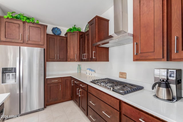 kitchen featuring stainless steel appliances, light tile patterned floors, and wall chimney exhaust hood