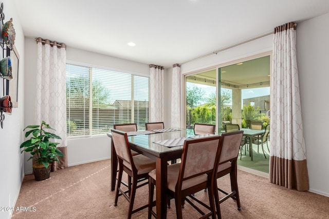 dining room with light carpet