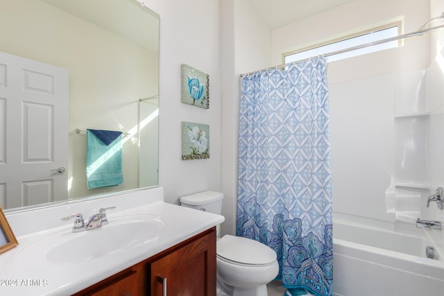 full bathroom featuring vanity, shower / bathtub combination with curtain, and toilet