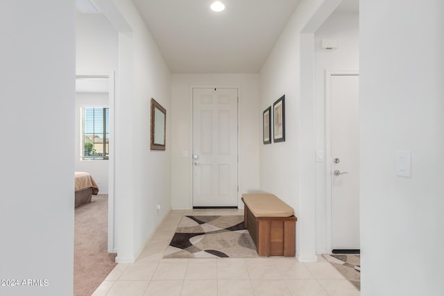 hall featuring light colored carpet